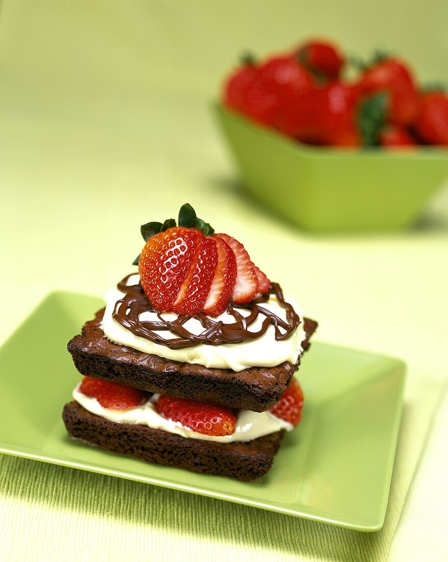 Brownie with cream and fresh strawberries