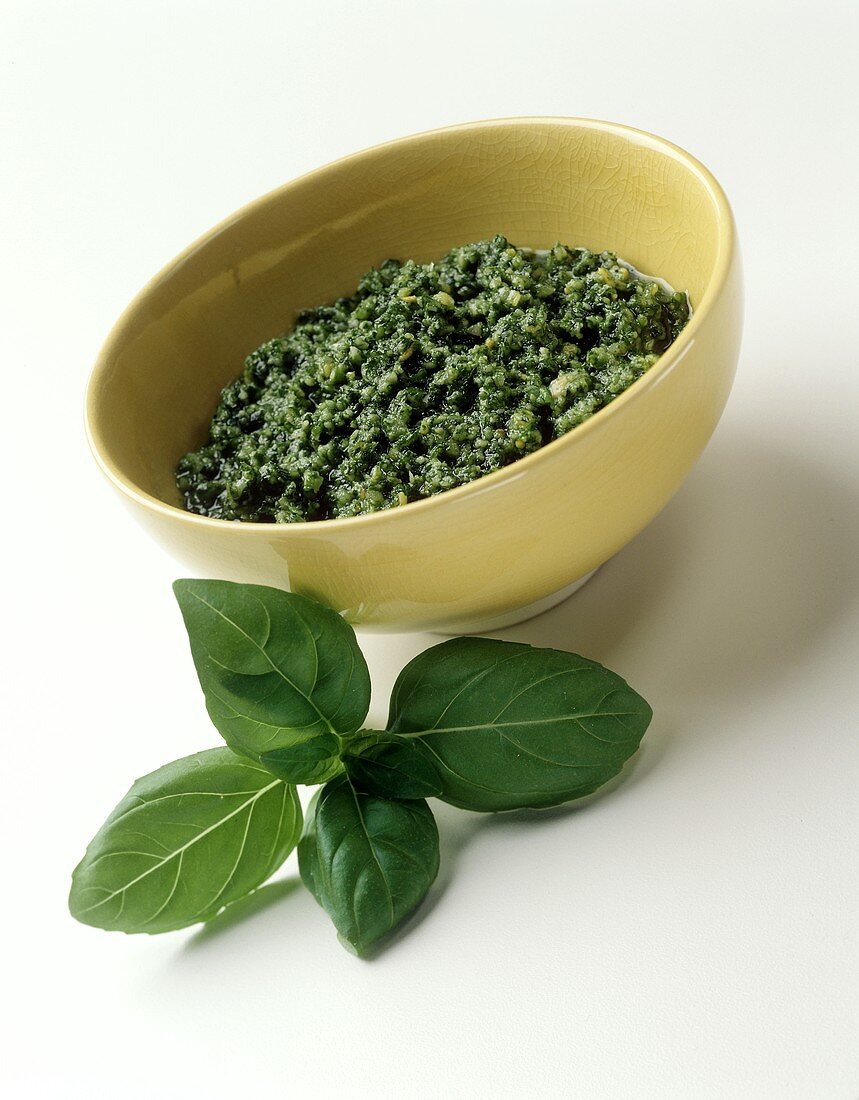 Pesto in bowl; fresh basil