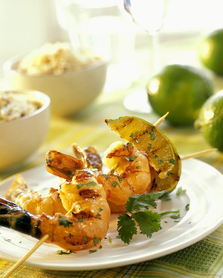 Barbecued shrimp kebab with wedges of lime
