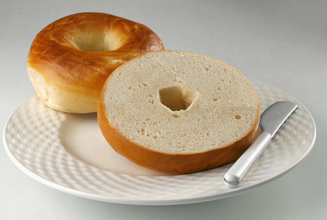 Plain Sliced Bagel on Plate with Knife