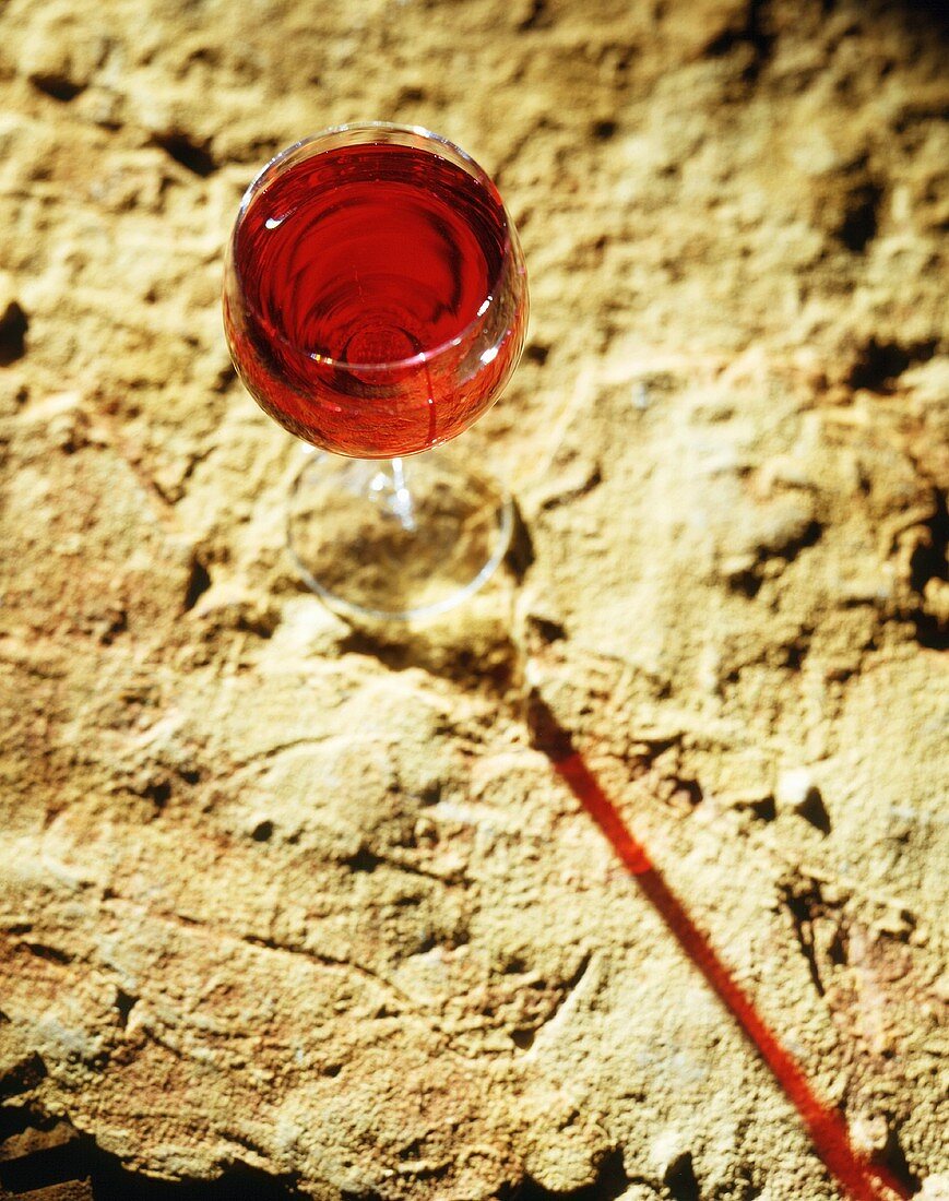 A Glass of Red Wine on Textured Stone Background