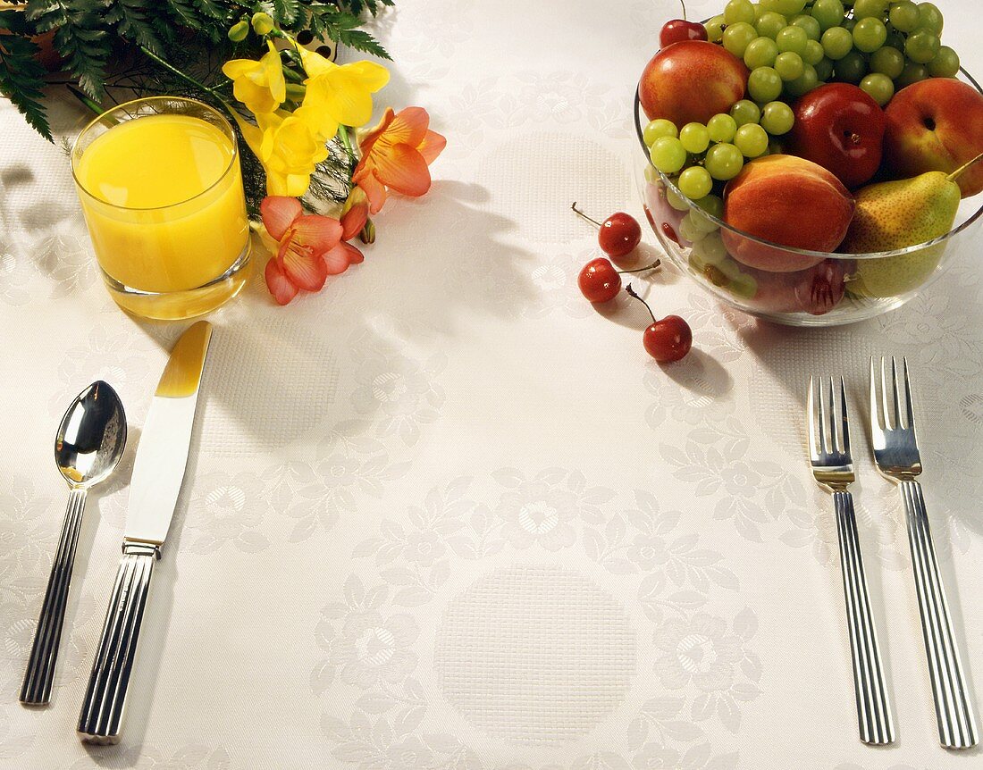 Place Setting with Orange Juice, Fruit Bowl and Flowers; No Plate