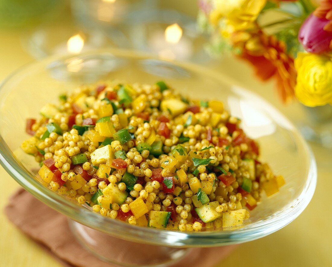 Spicy Couscous Salad with Bell Peppers in a Glass Pedestal Bowl