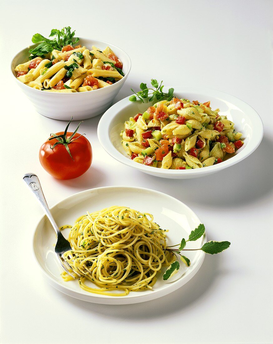Three noodle dishes with vegetables