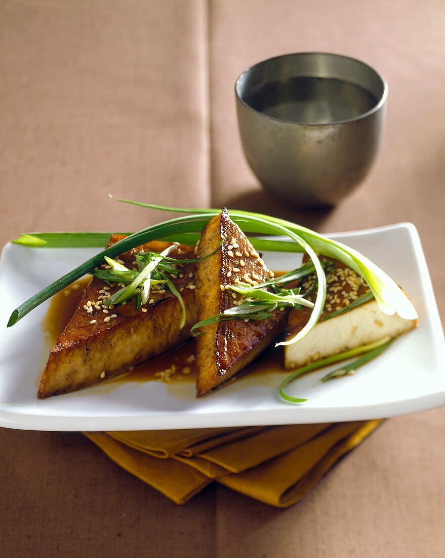 Fried tofu with sesame and spring onions