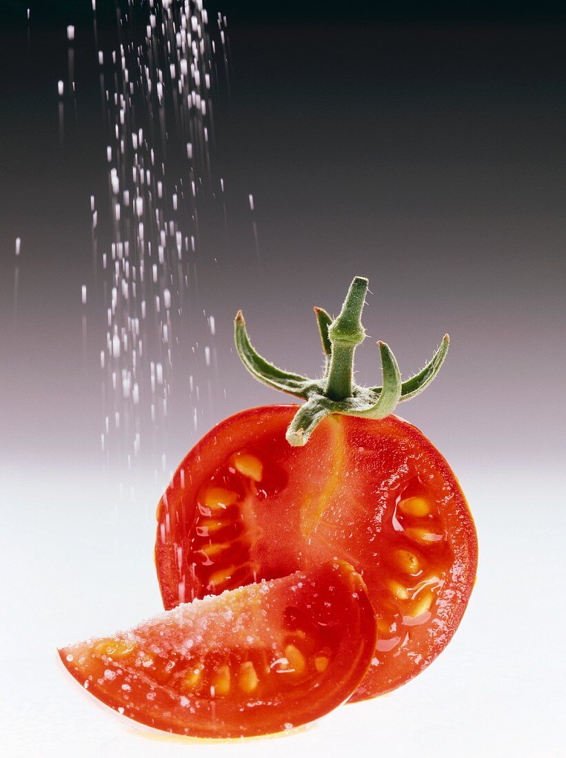 Pouring Salt on a Tomato Wedge