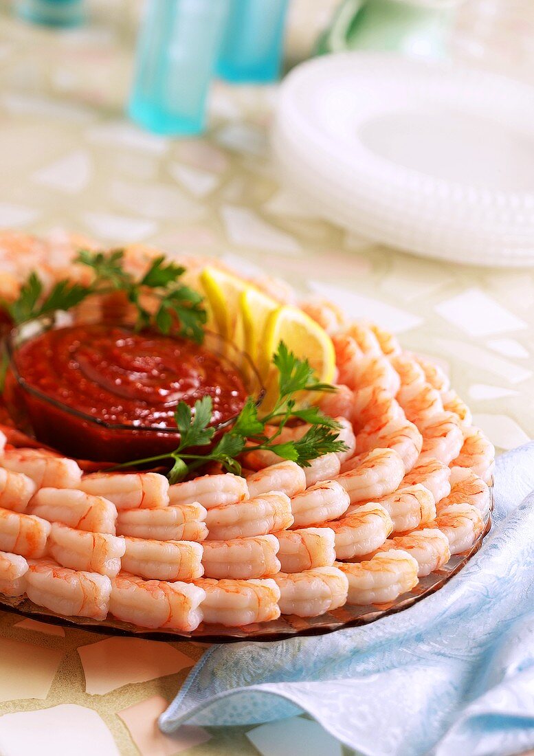 Shrimp platter with tomato sauce in the centre
