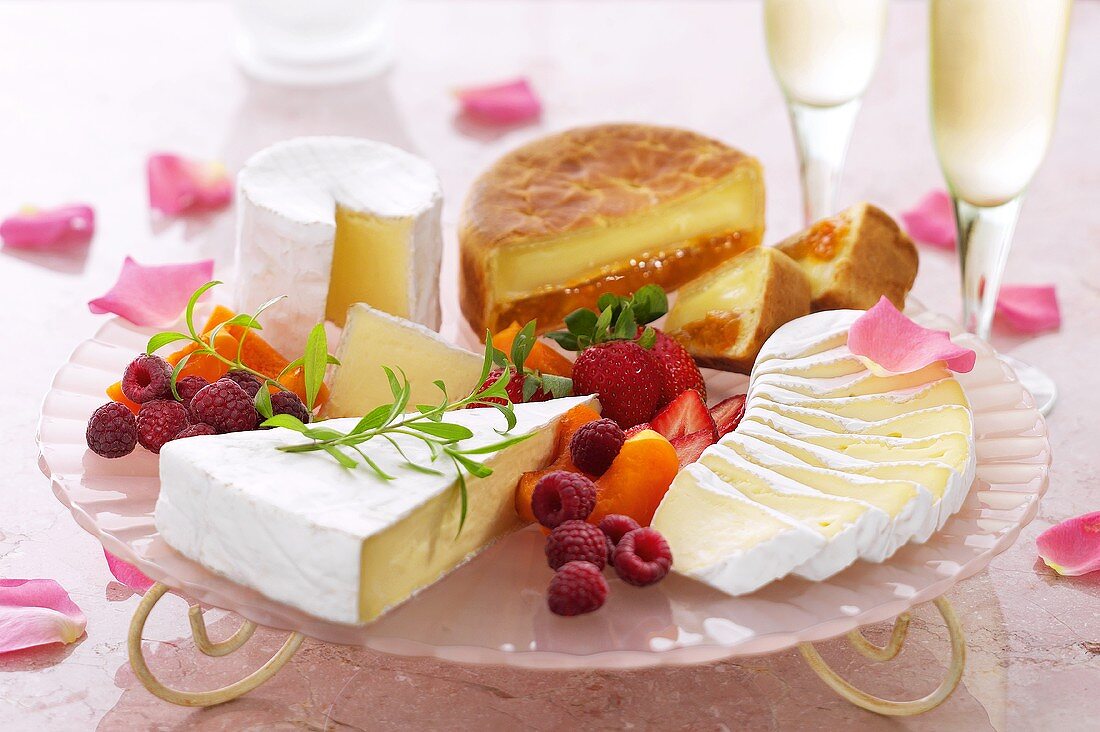 Platter of various soft cheeses and berries