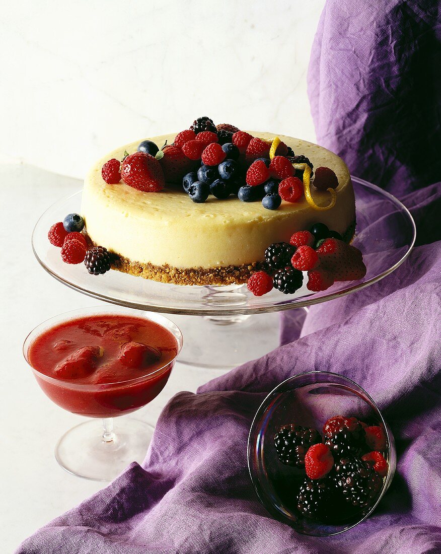 Cheesecake with mixed berries; strawberry puree