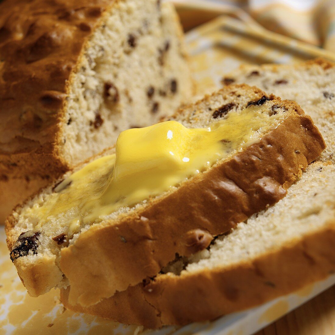 A Slice of Warm Raisin Soda Bread with Melting Butter