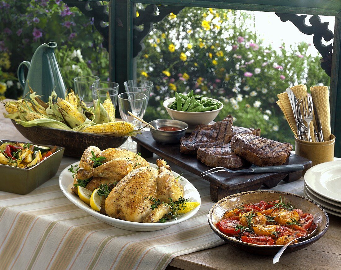 Rustic summer buffet with steaks and roast chicken