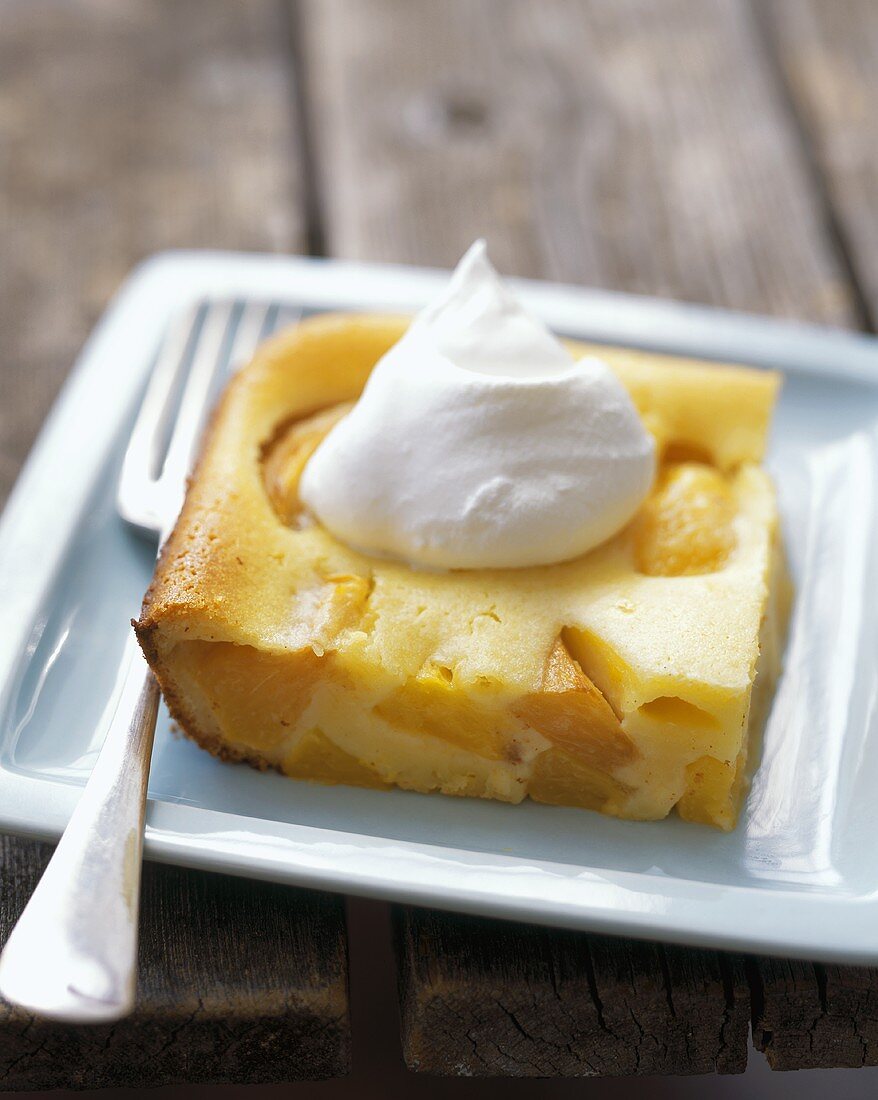 A Slice of Peach Cake with Whipped Cream