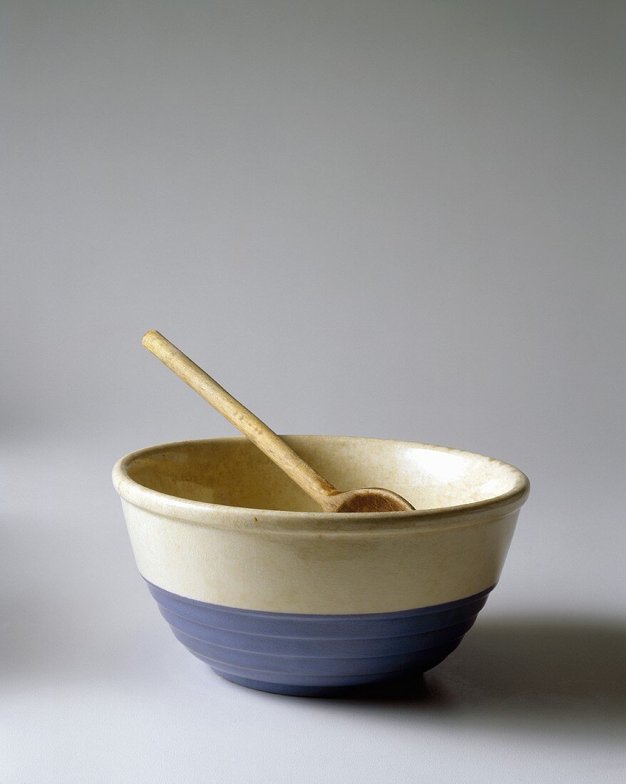 A Blue and White Mixing Bowl with a Metal Spoon