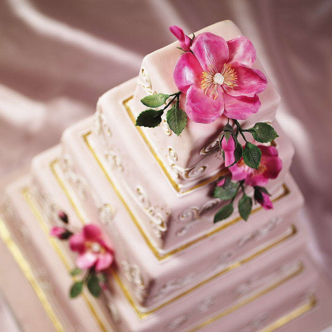 A Multi-tiered Wedding Cake with Pink Flowers