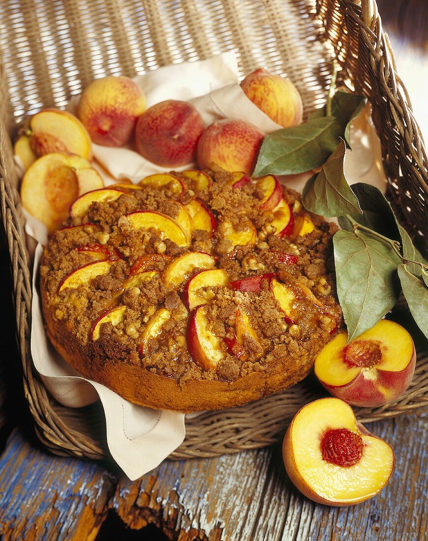 Peach Coffee Cake in a Basket with Fresh Peaches