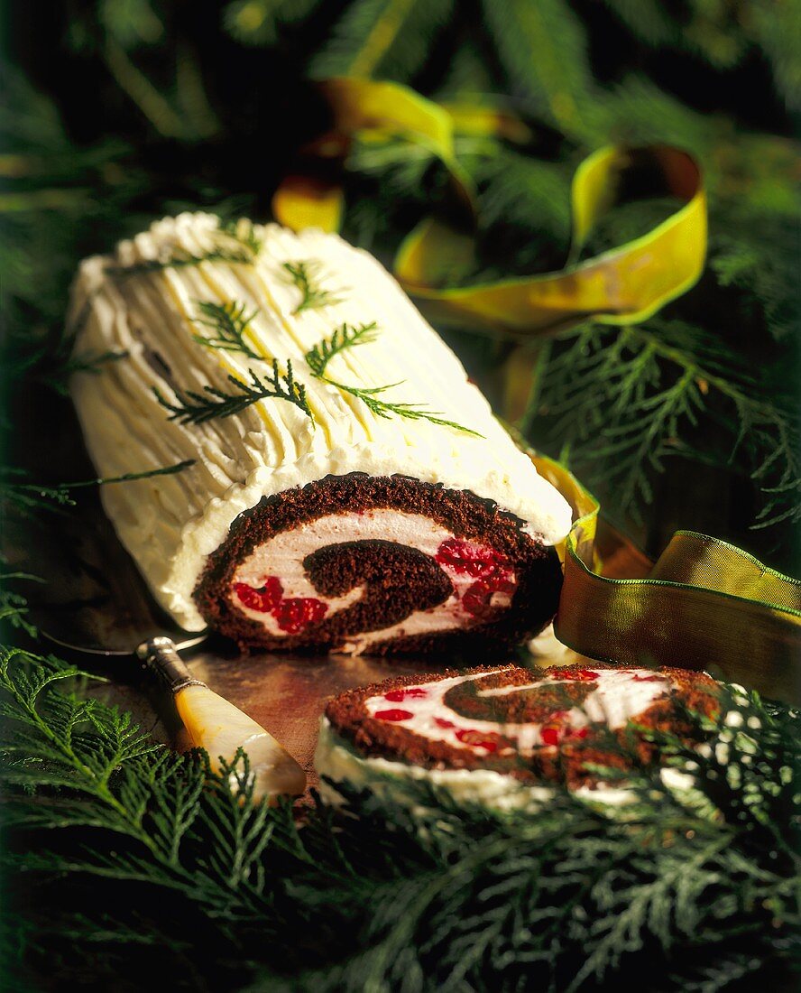 A Chocolate Yule Log with Raspberry Filling and White Chocolate Frosting