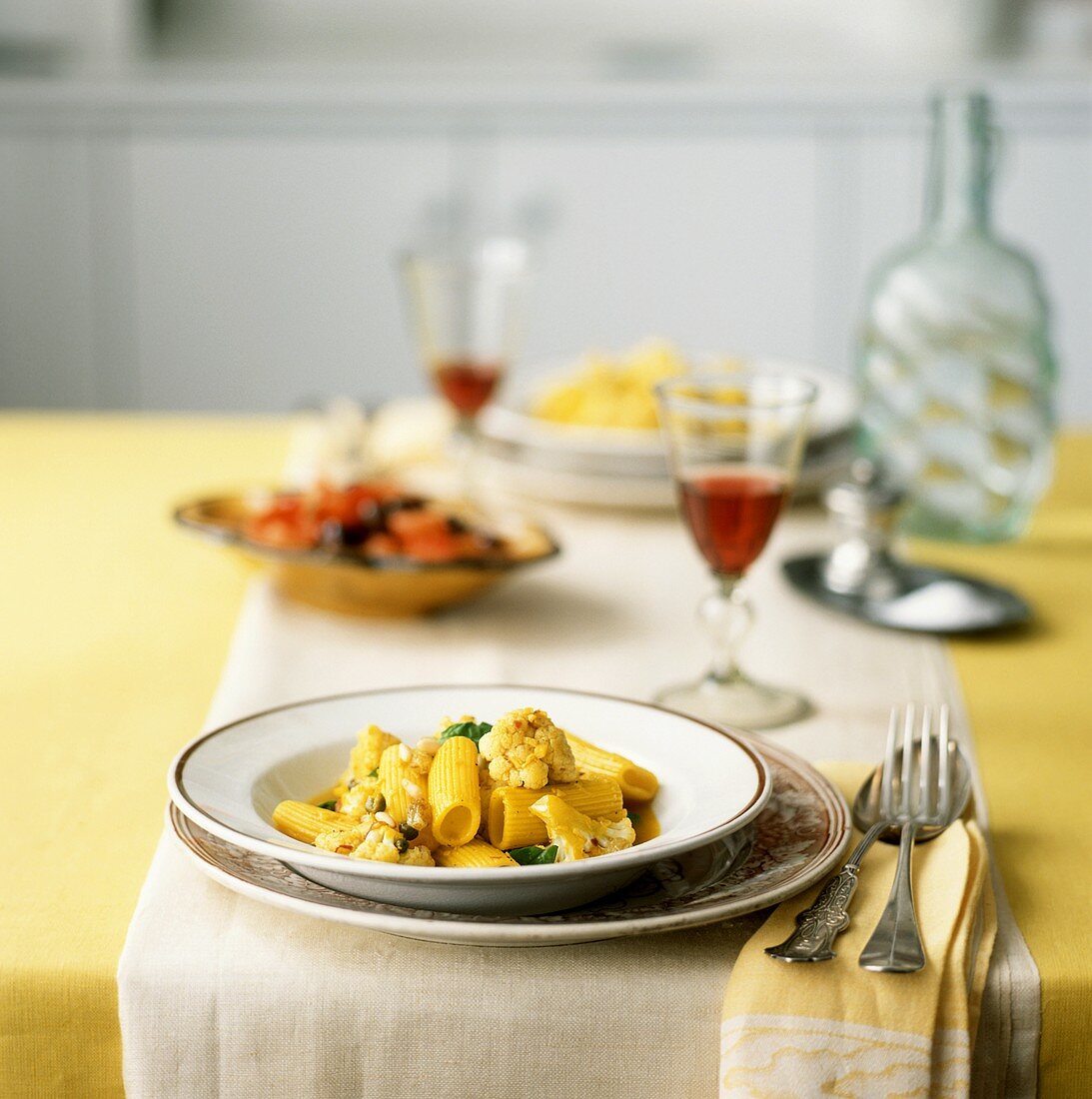 Curried ziti, capers and cauliflower on a laid table