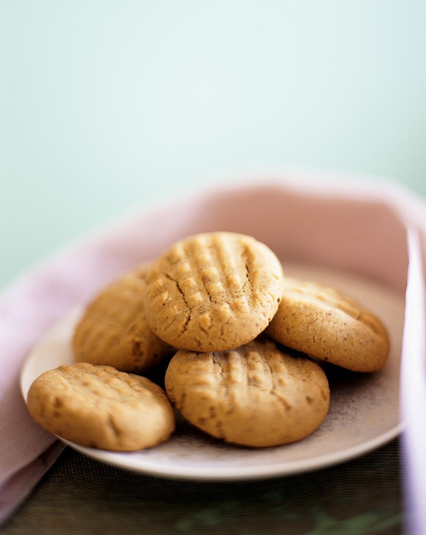Peanut biscuits on plate with pink cloth