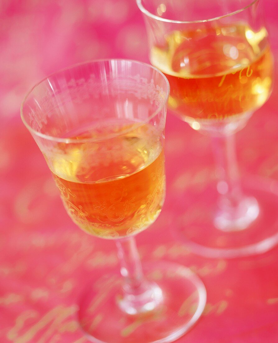 Two Glasses of White Wine on Pink