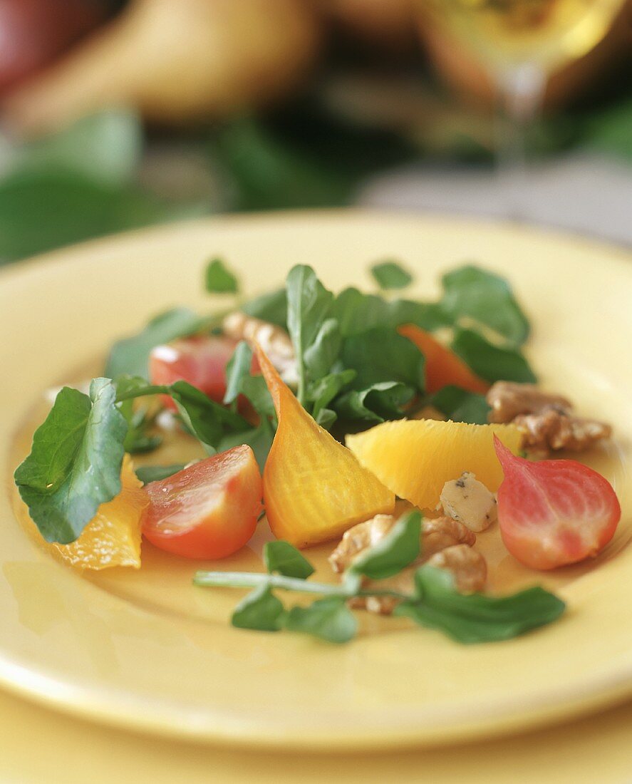 Salad with yellow beetroot, nuts and orange segments