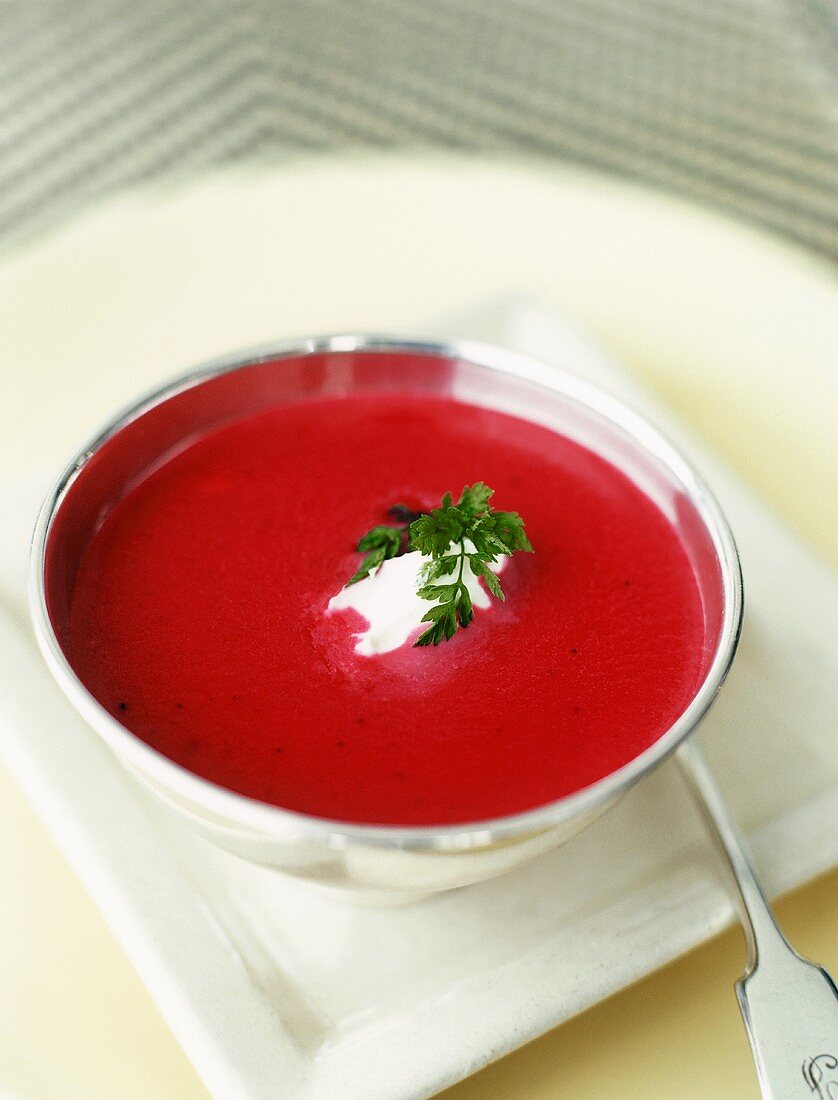 A Bowl of Beet Soup with Creme Fraiche and Parsley
