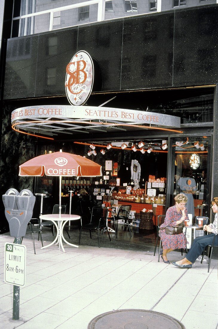 People at Tables Outside a Coffee Shop