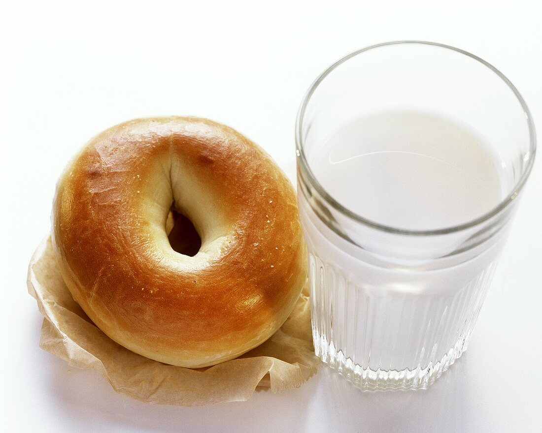 A Plain Bagel with a Glass of Milk