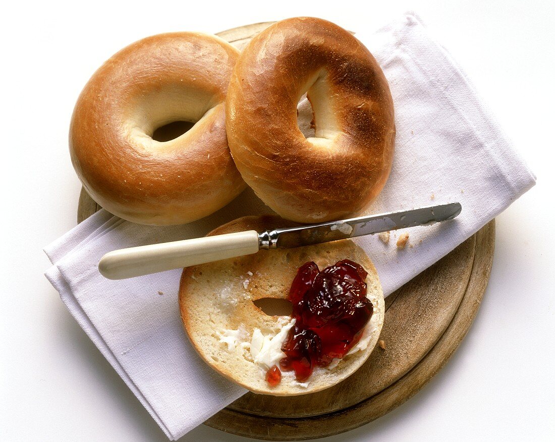 Two Bagels and a Half of Bagel with Butter and Jelly