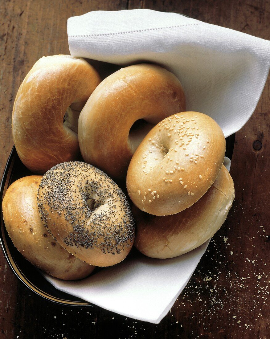 Assorted Bagels on a Cloth in a Bowl