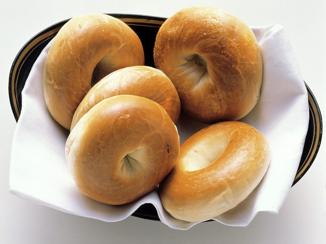 Plain Bagels on a Cloth Napkin in a Bowl