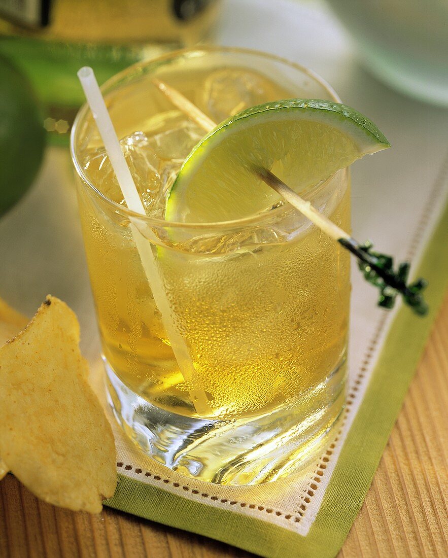 A Glass of Whisky and Ginger with a Lime Slice; Potato Chip