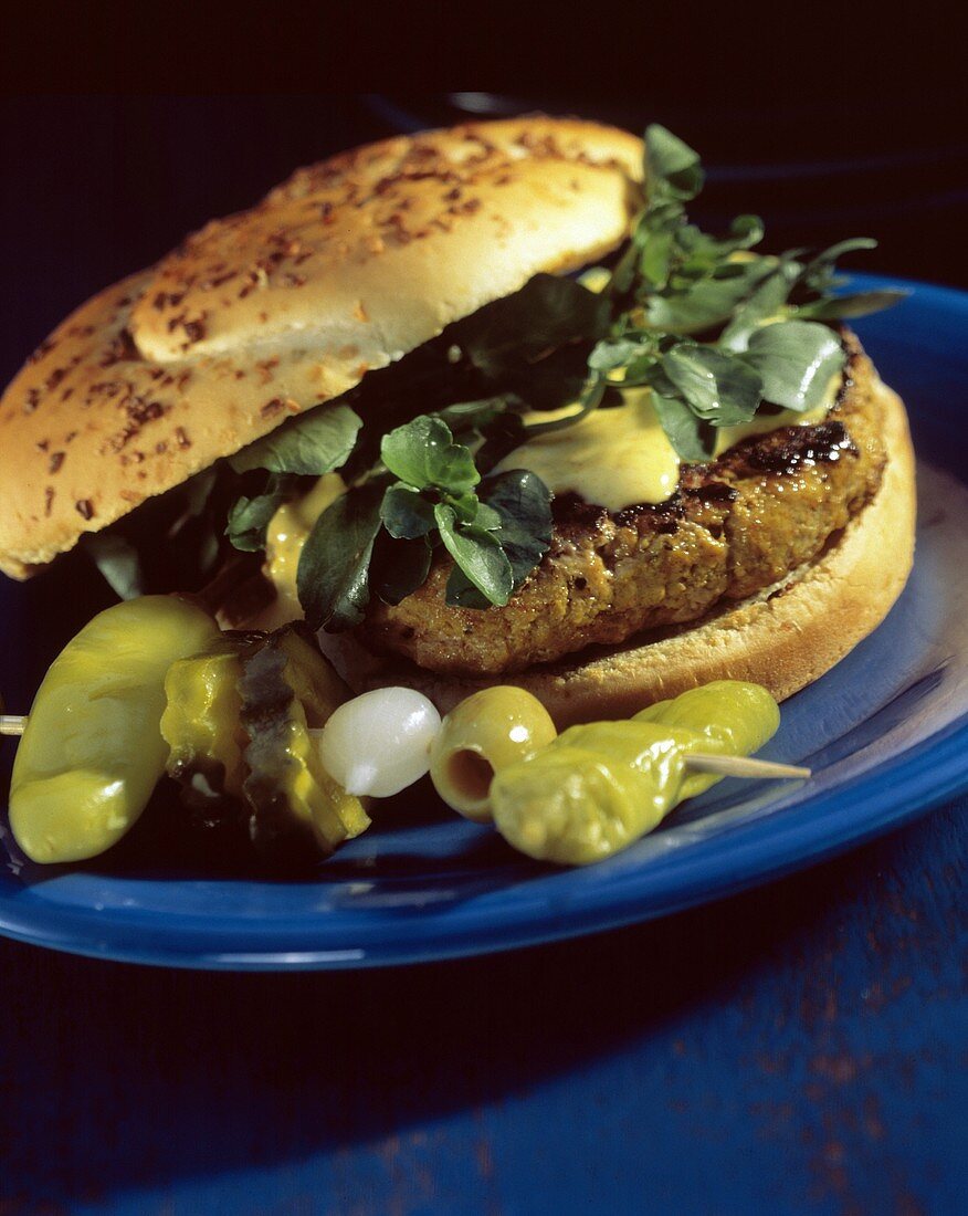 A Hamburger with Watercress and Mustard; Pepperoncinis