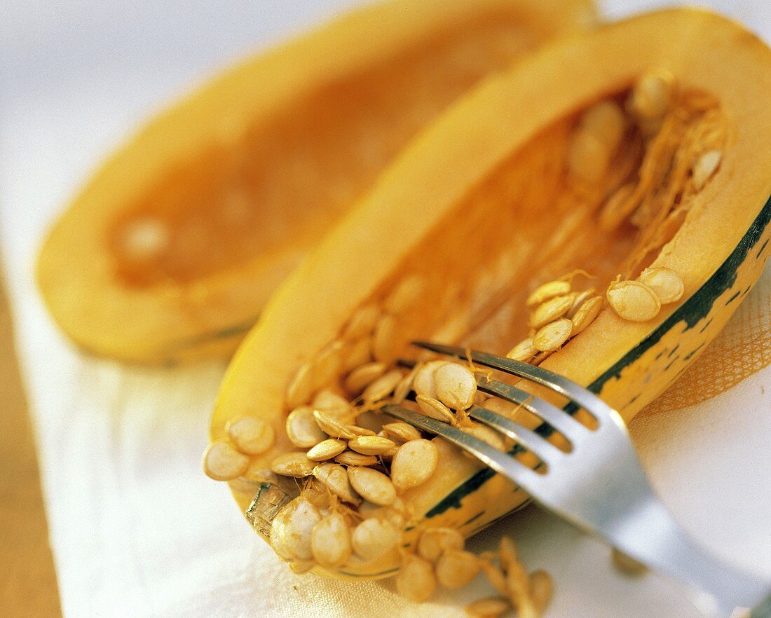 A Fork Removing Seeds from a Delicata Squash