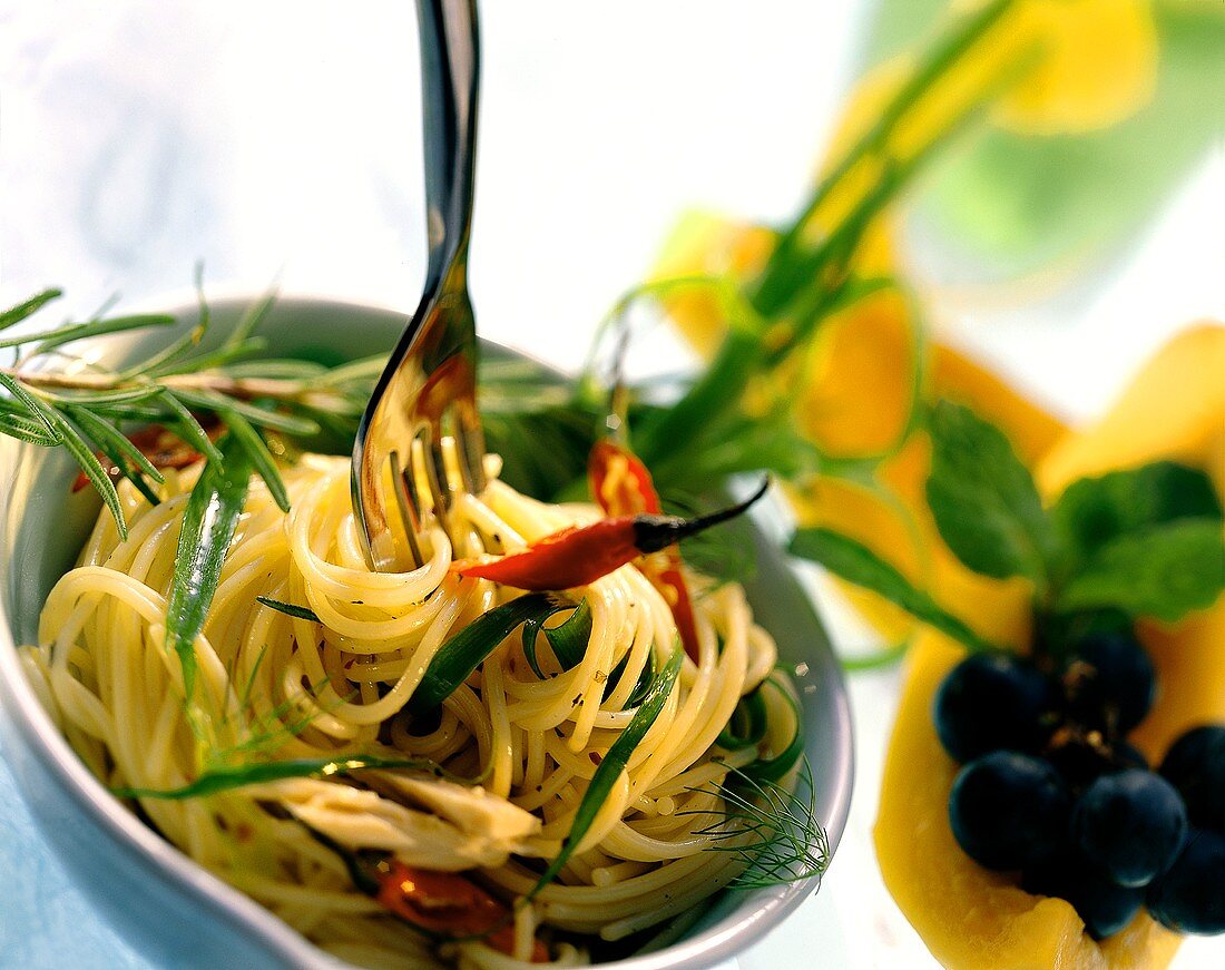 A Fork Twirling Spaghetti with Fresh Herbs