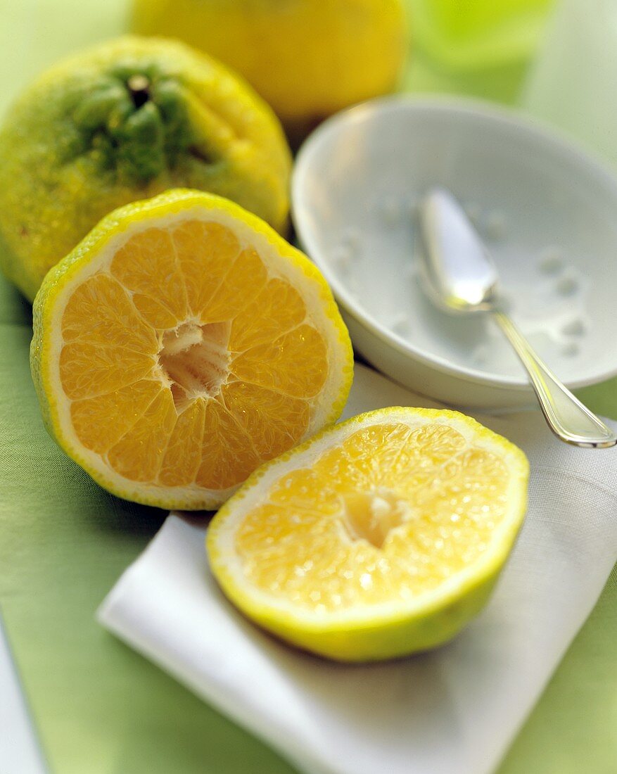 Ugli Fruit Cut in Half; White Bowl with Spoon