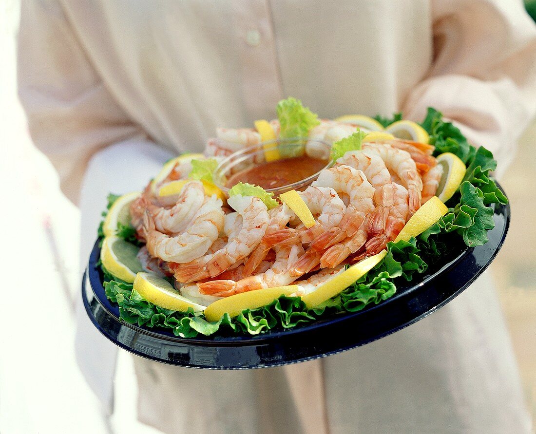 Person Holding a Shrimp Platter