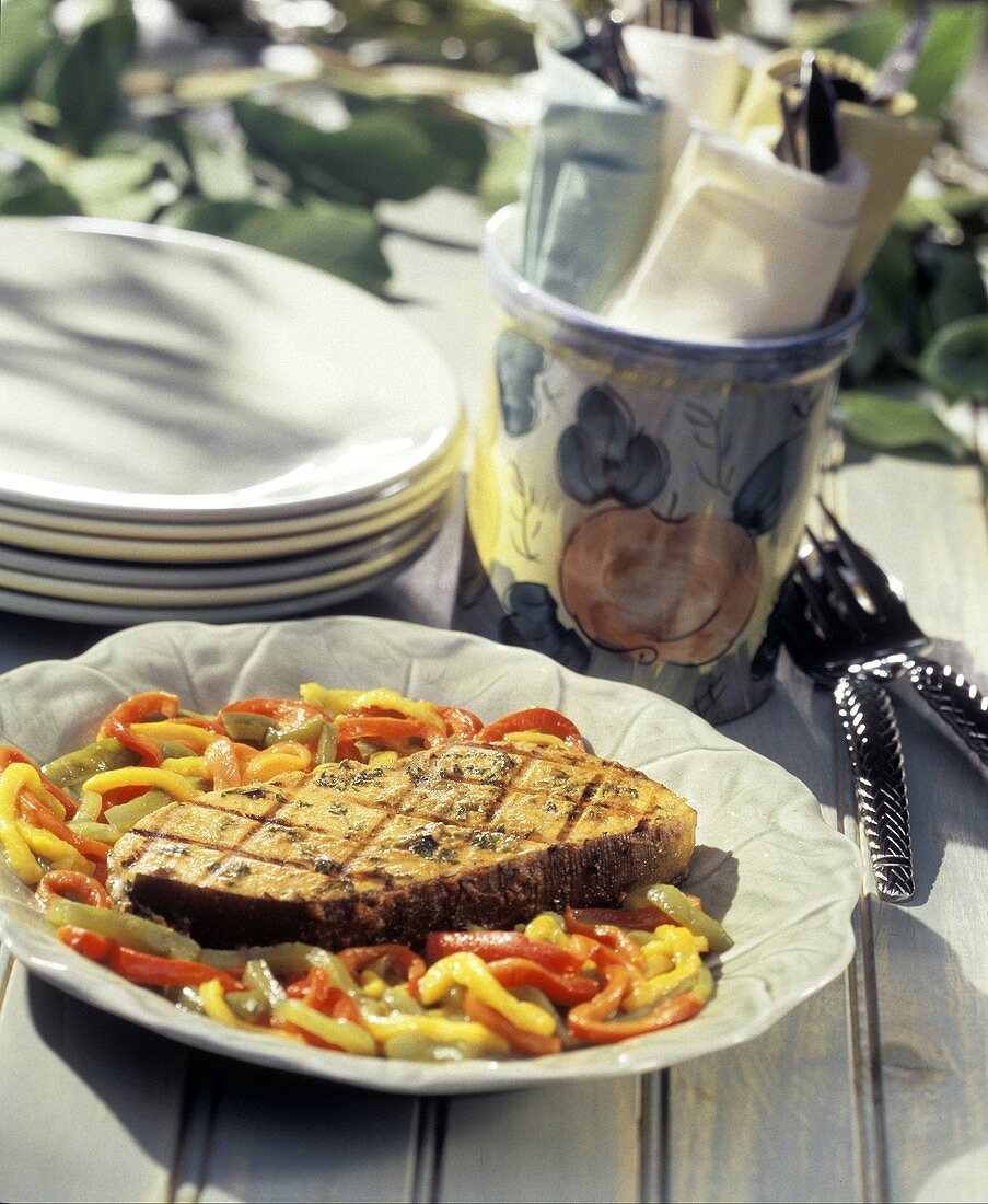 Grilled Swordfish with Peppers on an Outdoor Table
