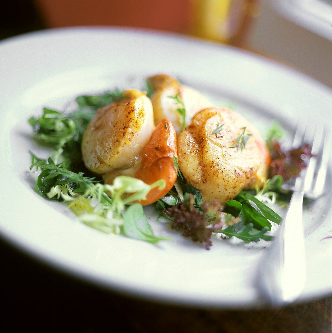 Gebratene Jakobsmuscheln auf gemischtem Salat