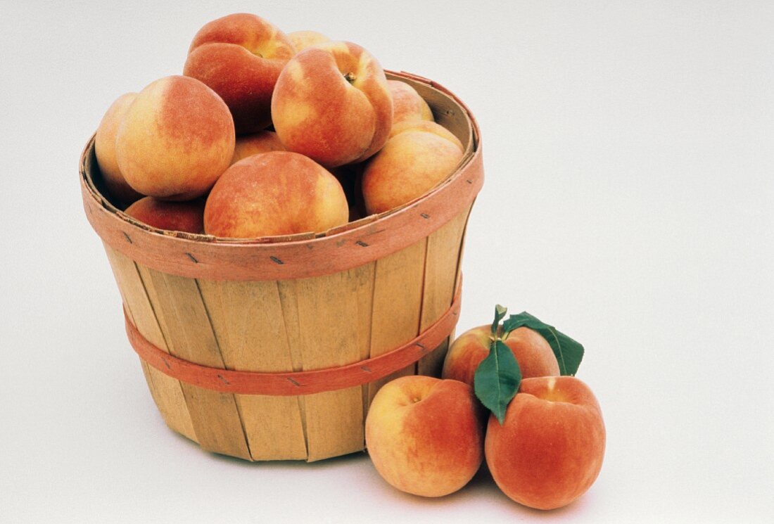 Peaches in and Next to a Basket
