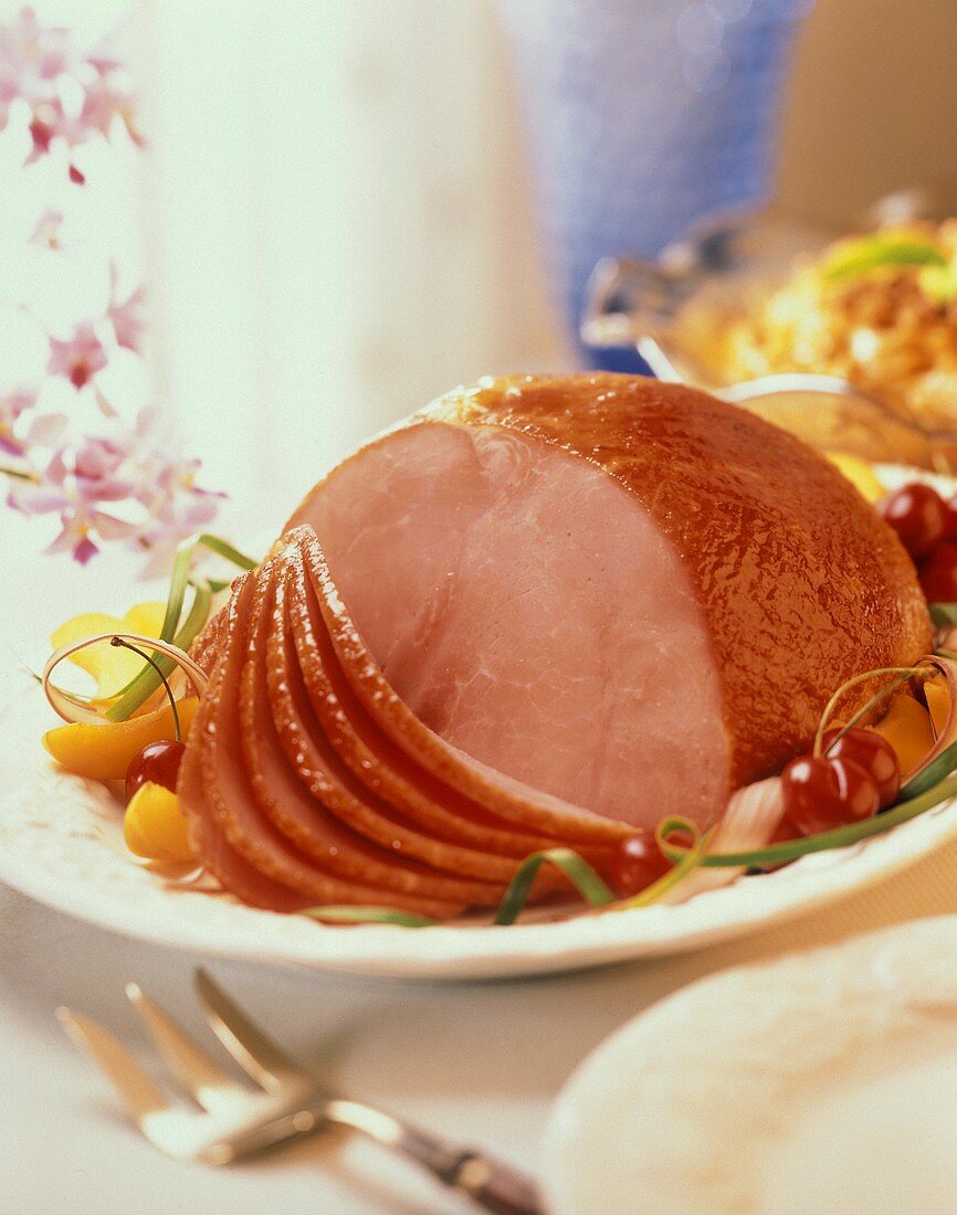 Partially Sliced Glazed Ham on a Platter