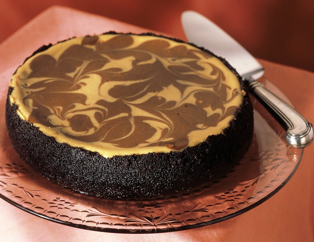 Chocolate peanut butter swirl cheesecake on glass plate