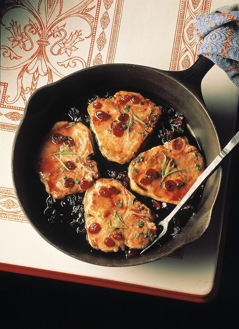 Pork Chops with Cranberry Sauce in a Skillet