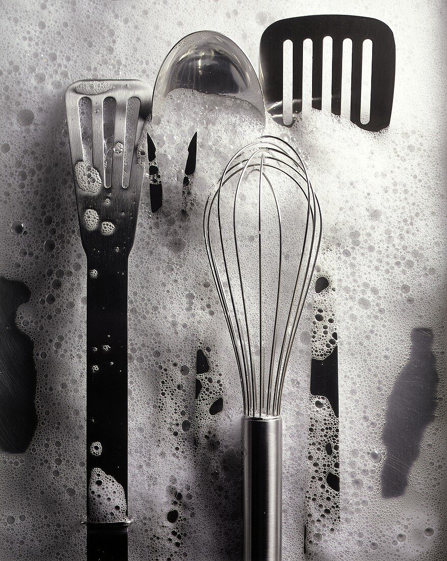 Stainless Steel Kitchen Tools in Soapy Water
