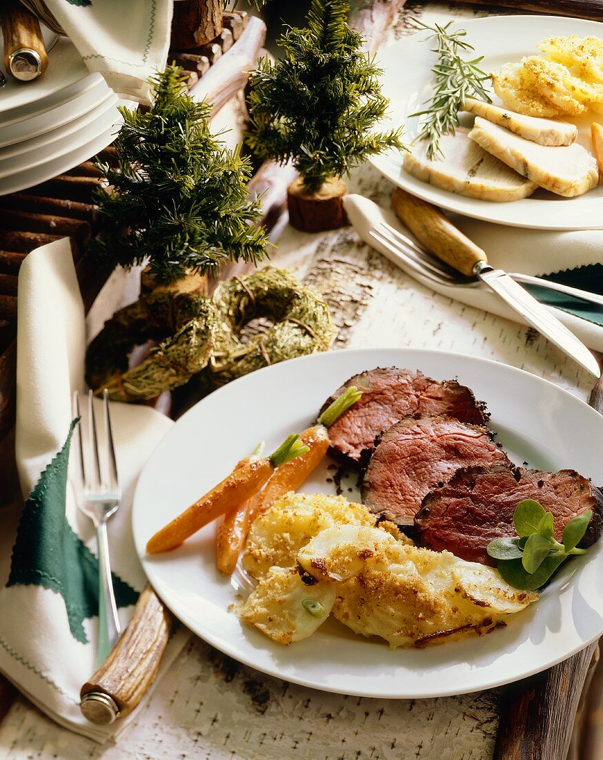 Holiday Dinner Plate with Sliced Roast Beef, Sliced Baked Potatoes and Carrots