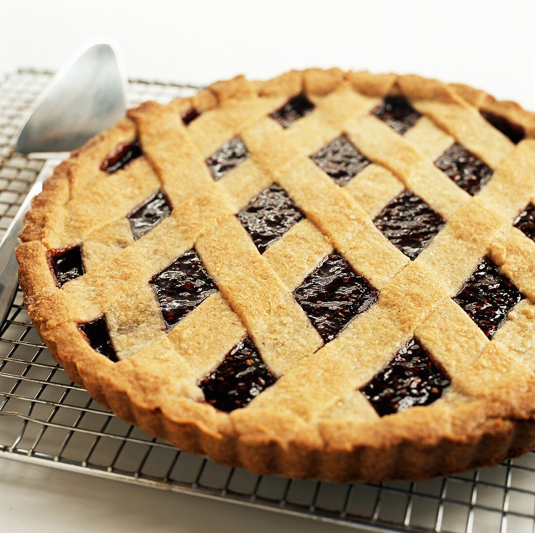 Raspberry tart on cake rack