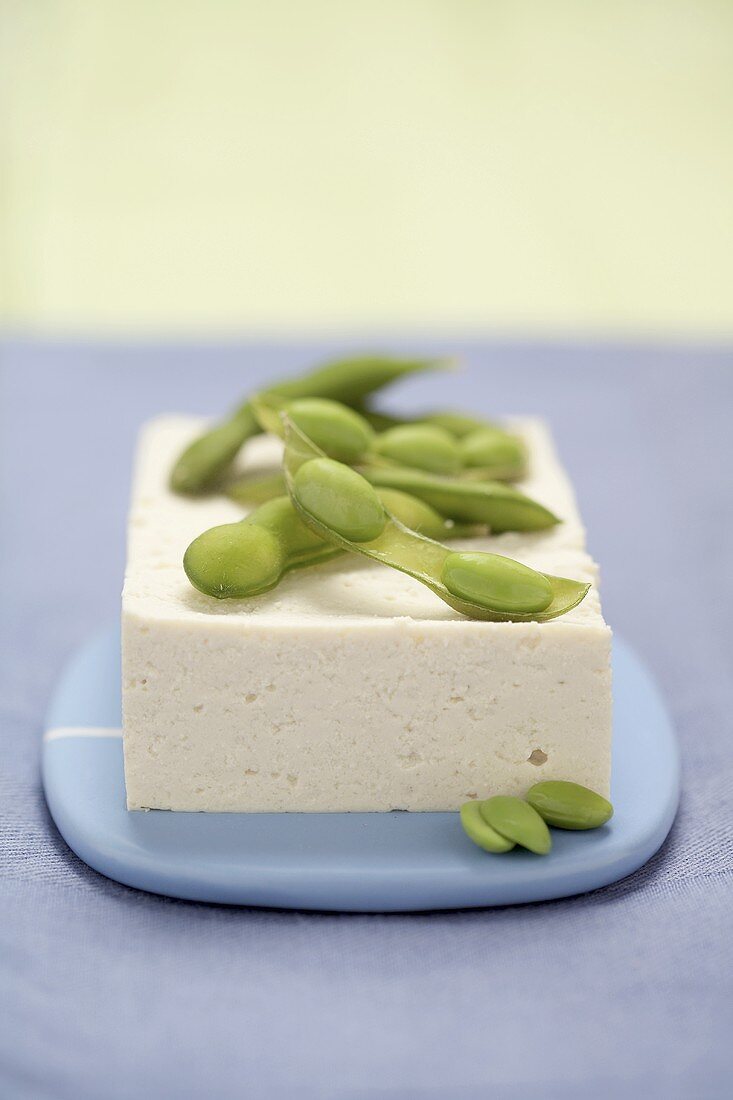 Green soya beans on a block of tofu