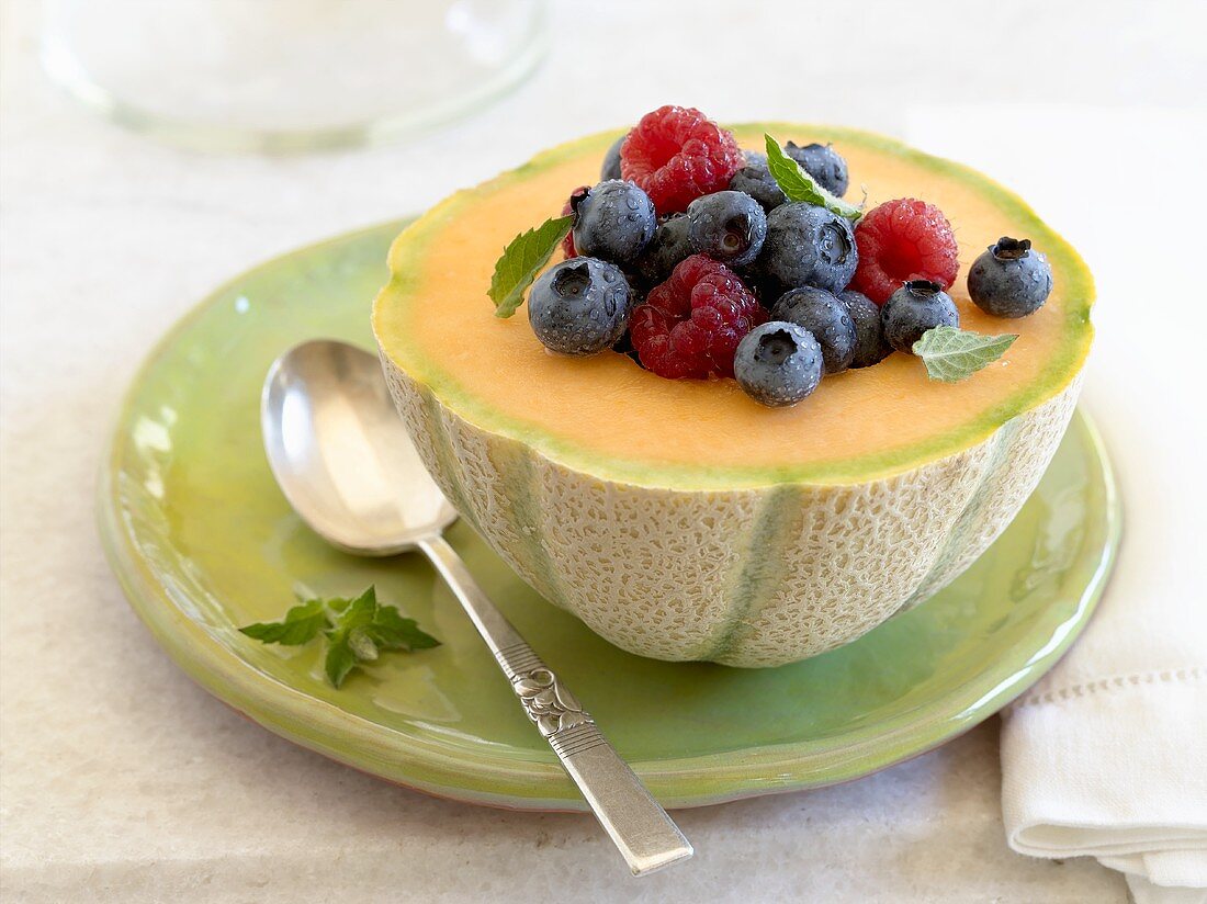 Fresh berries on cantaloupe melon half