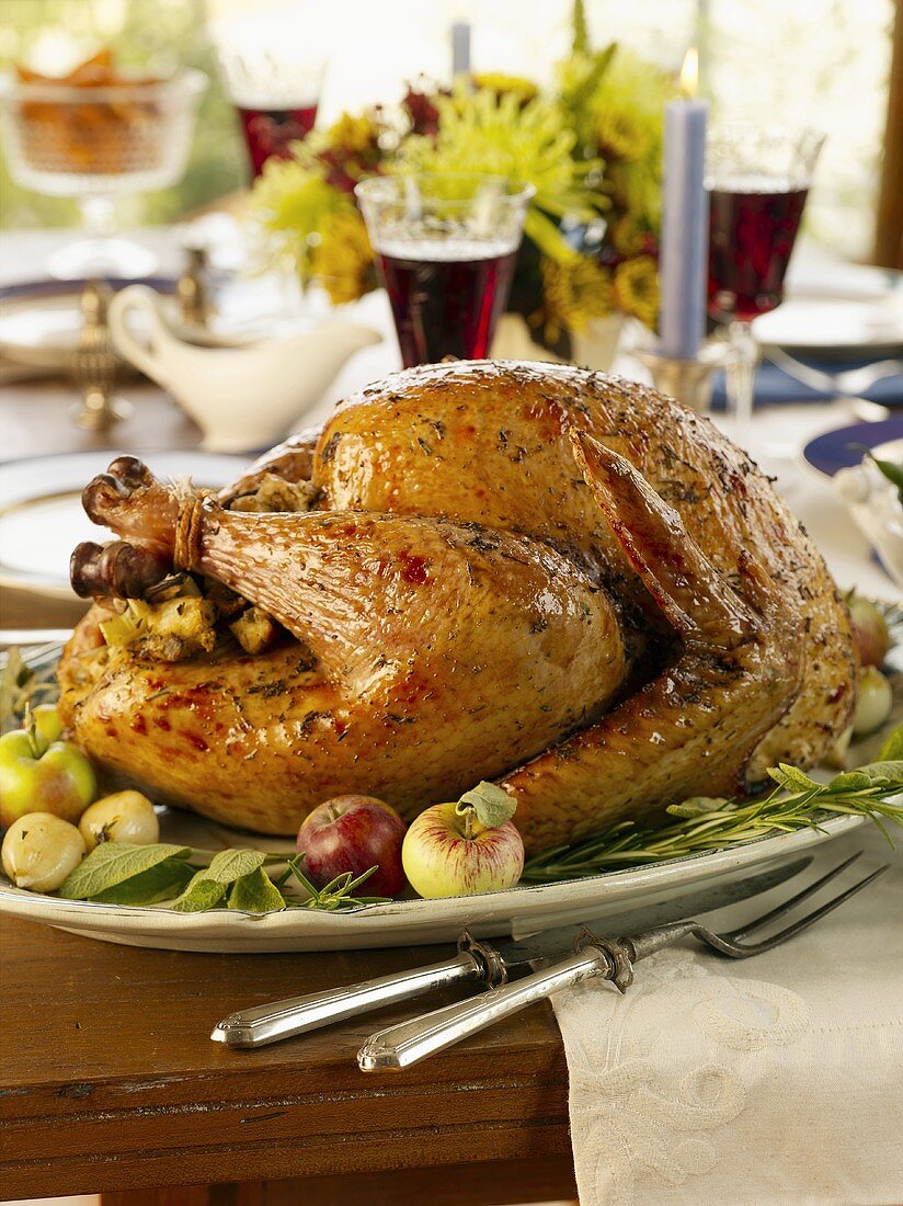 Roast stuffed turkey on laid table (USA)