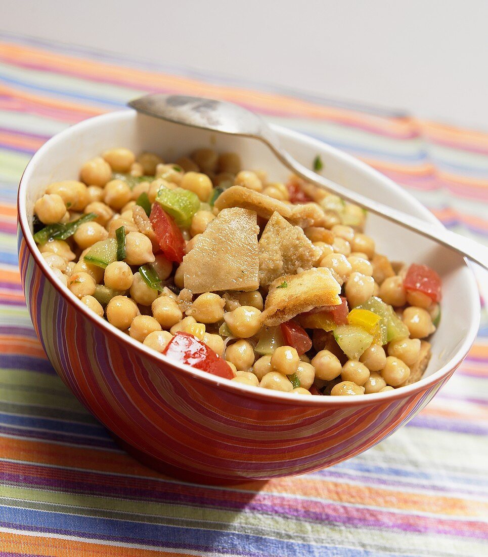 Chick-pea salad in bowl with spoon