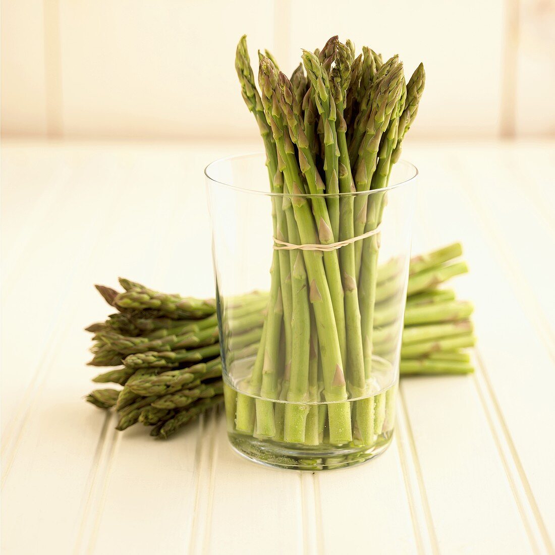 Asparagus Bundle in a Glass with Water with Bundle of Asparagus Next to Glass